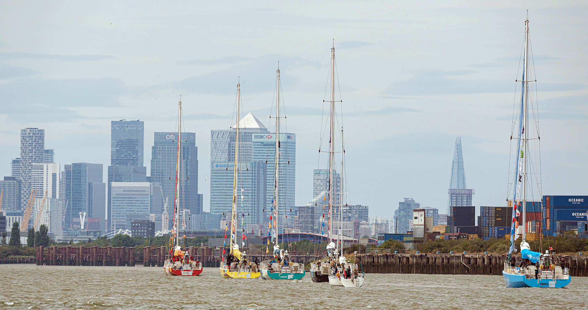 Yachts approach the Canary Wharf skyline
