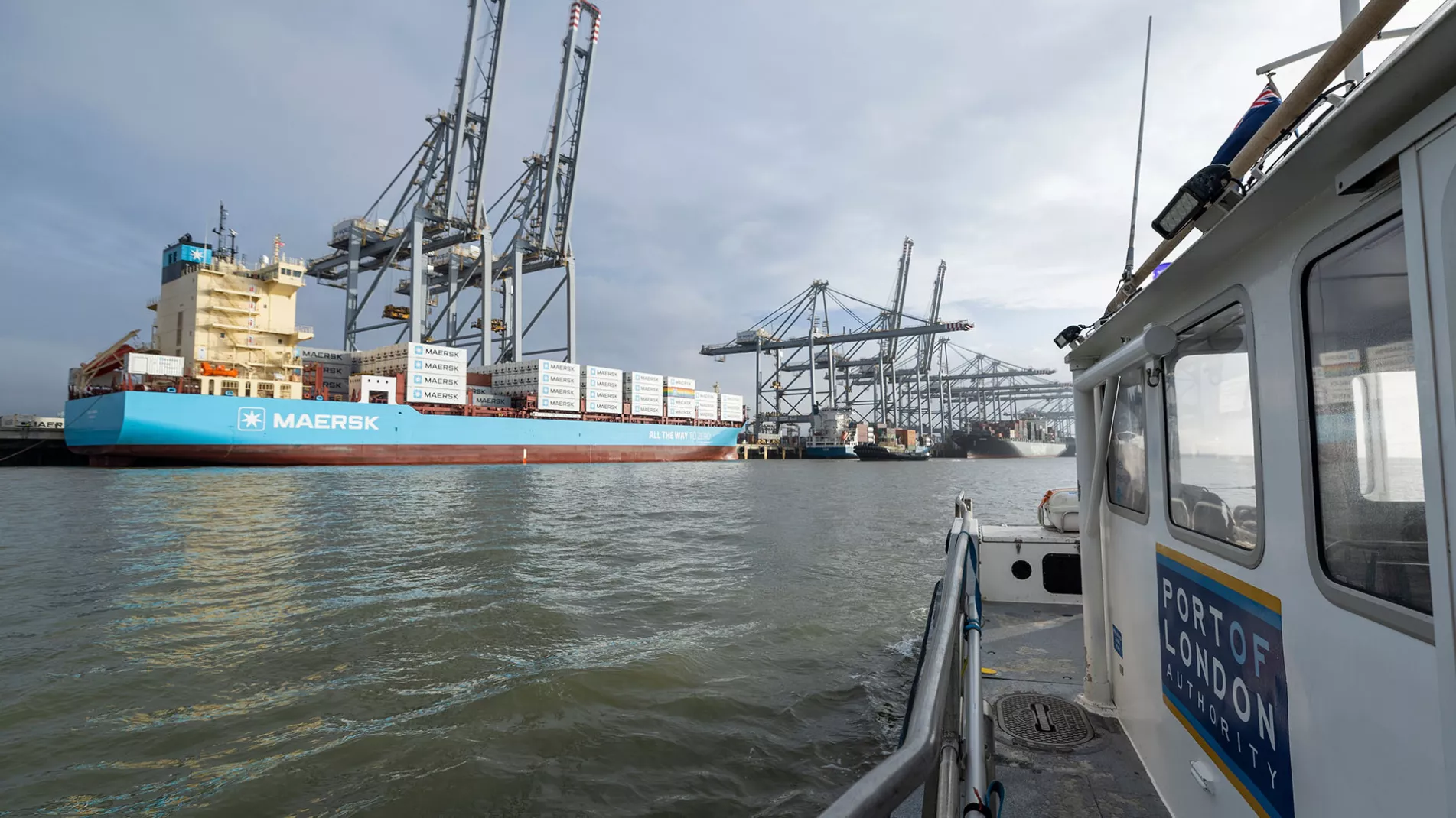Laura Maersk Container Ship at London Gateway with PLA Harbour Service Launch vessel in foreground
