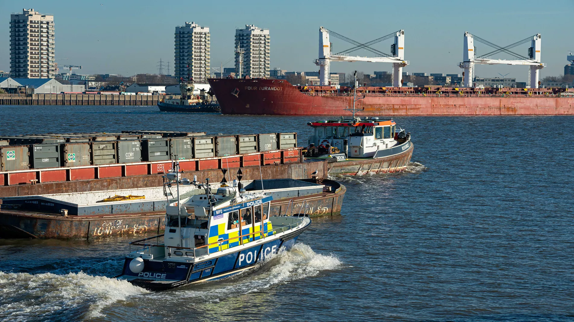 Busy river Police tug freighter woolwich