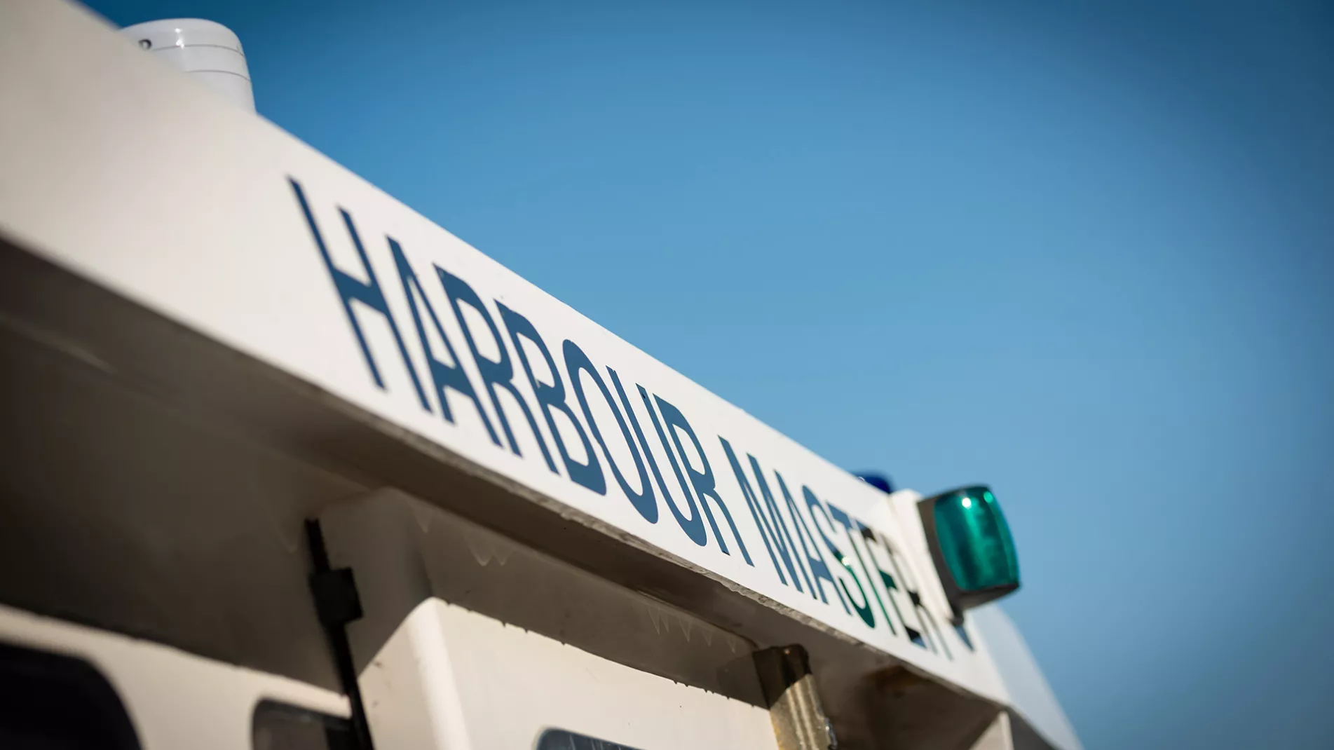 A harbour master sign on the side of a boat