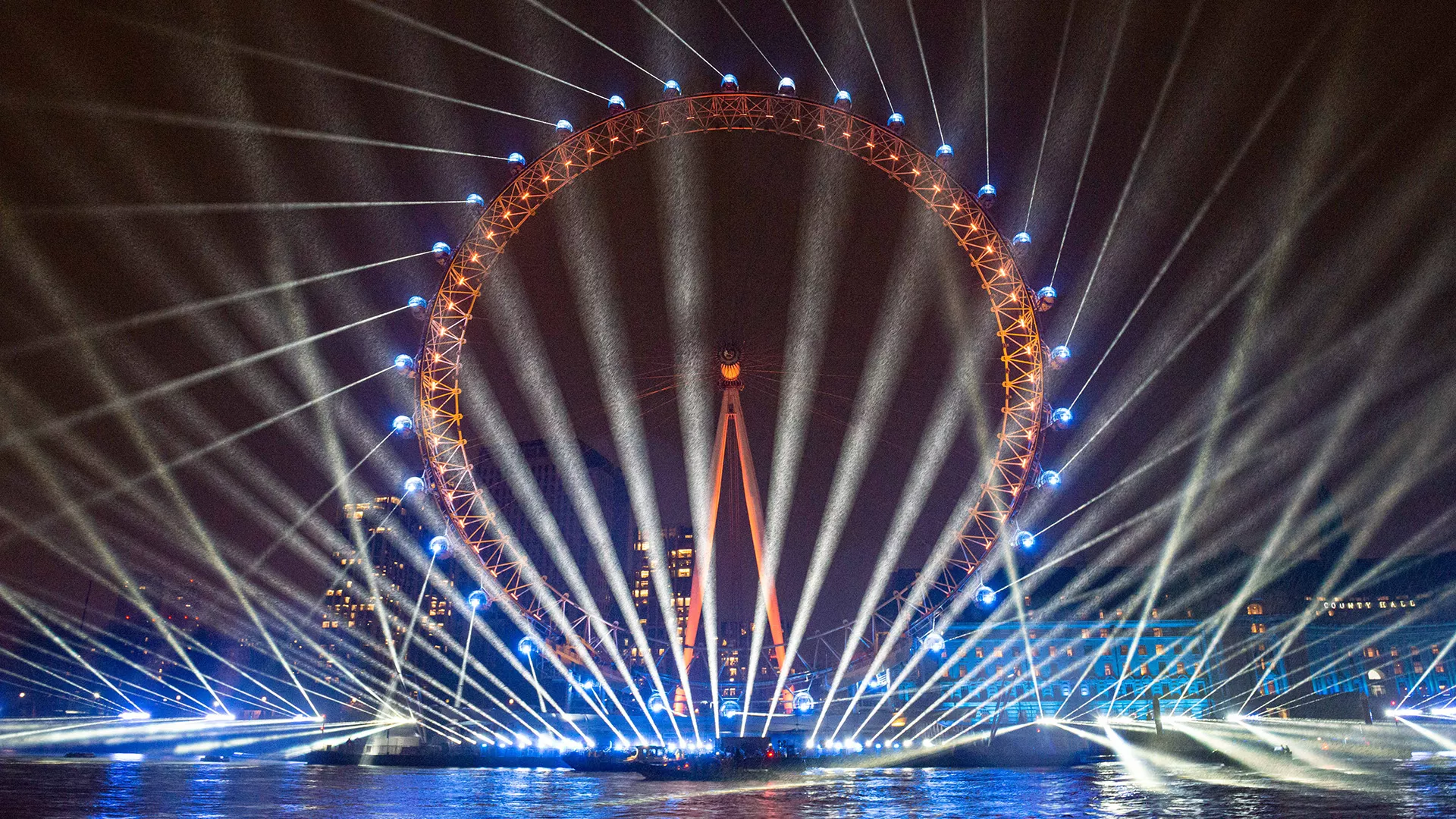 Laser lights encircle the London Eye during New Years Eve festivities