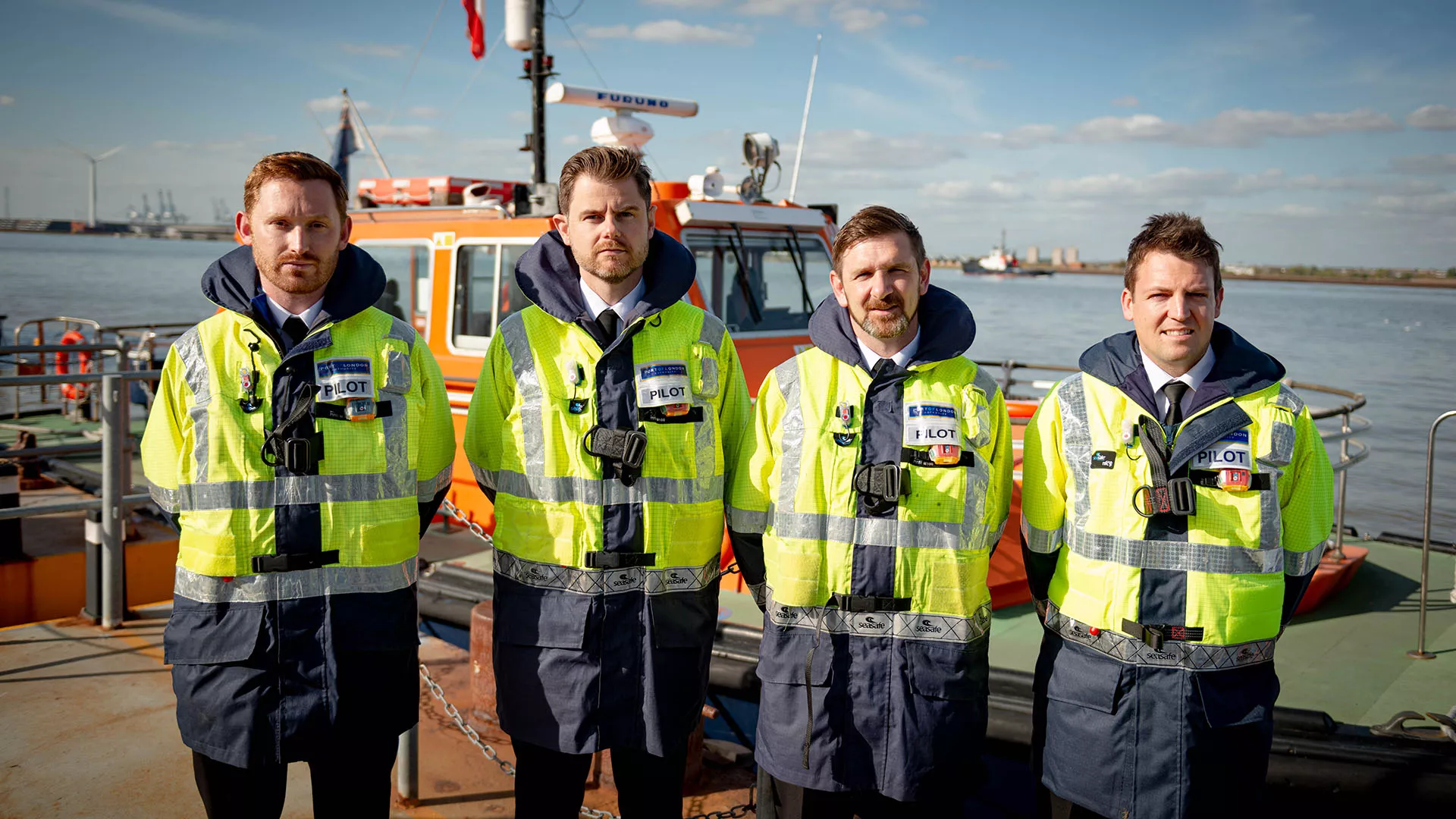 Four new Trainee PLA Pilots with a PLA Pilot cutter vessel in the background