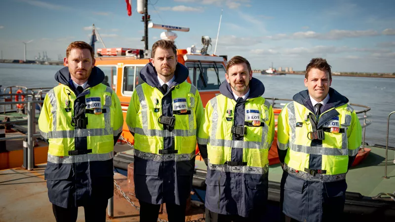 Four new Trainee PLA Pilots with a PLA Pilot cutter vessel in the background