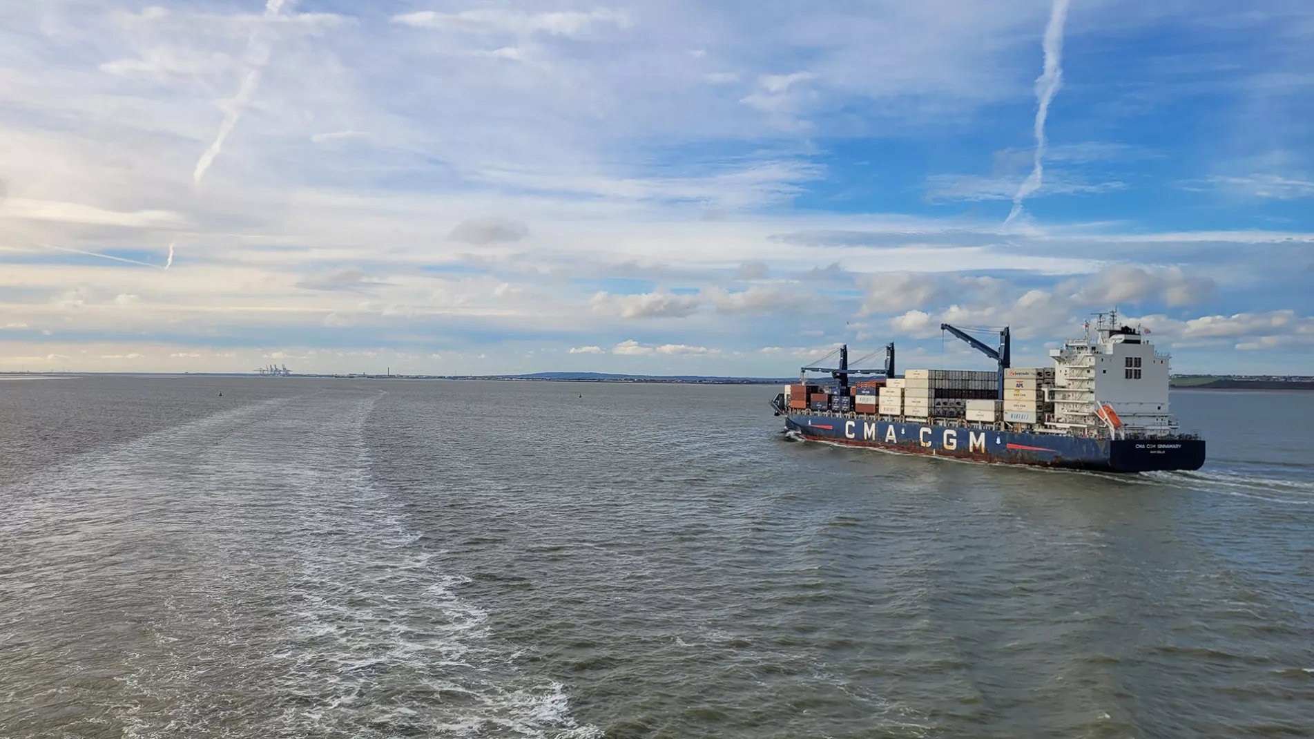 Cargo ship blue sky clouds Thames Estuary